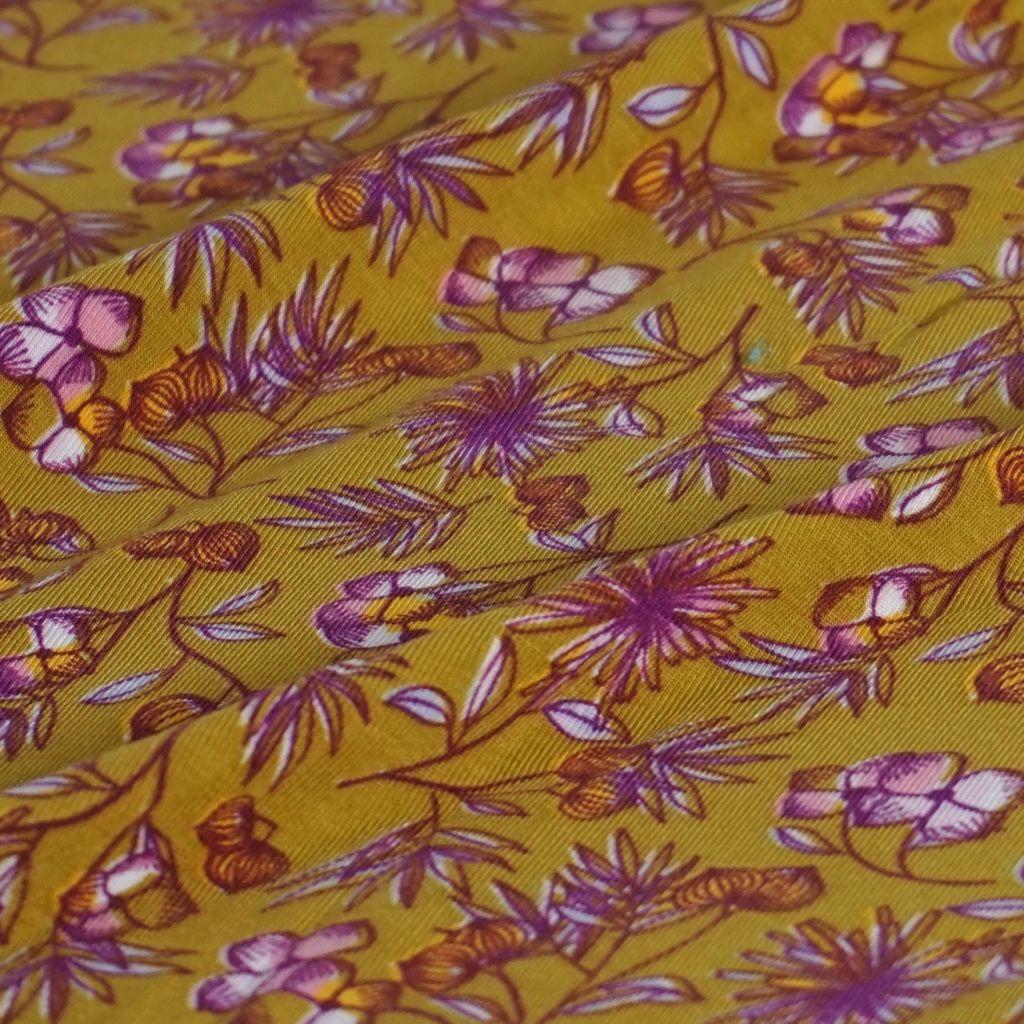 Modaljersey Blümchen violett auf senfgelb