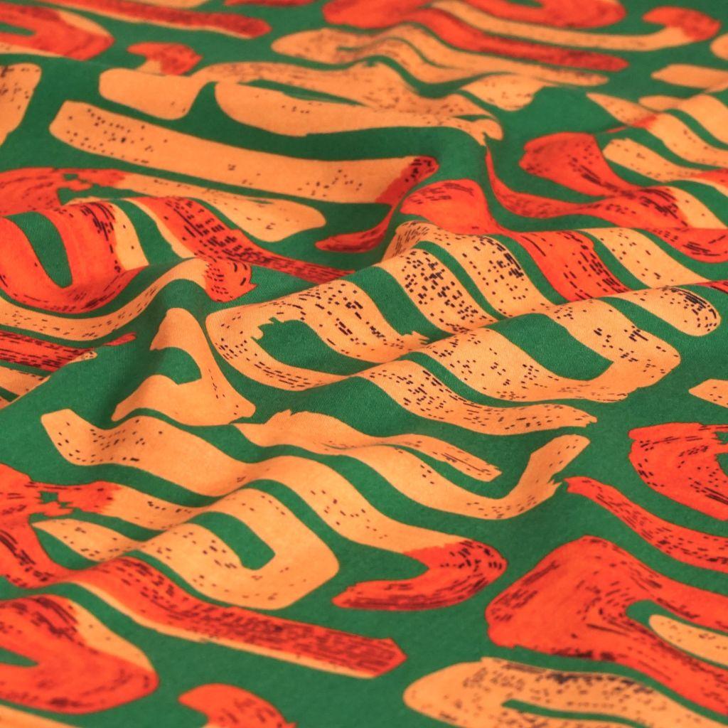 Viskose Druck grafisches Muster apricot rot grün